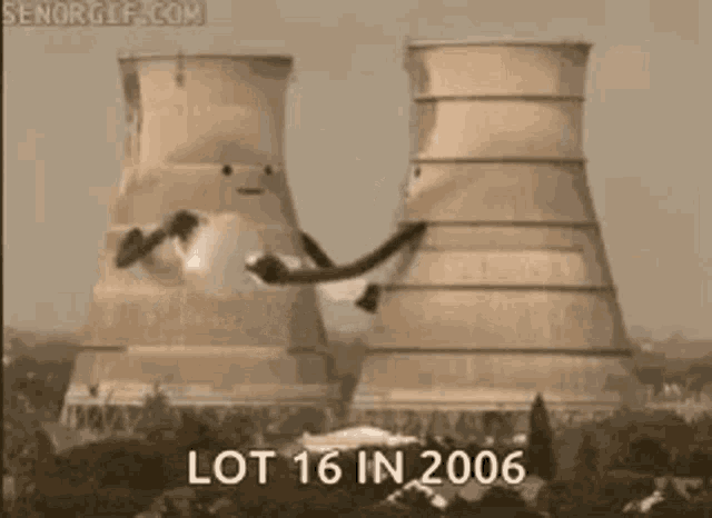 a lot of smoke is coming out of a cooling tower .