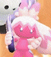 a person is holding a pink stuffed animal and a white stuffed animal .