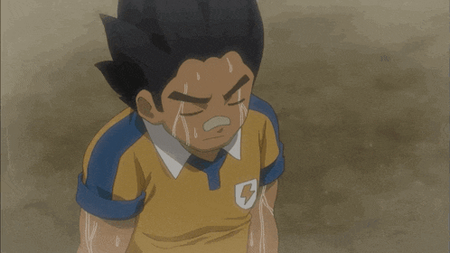 a boy in a yellow and blue shirt with a lightning bolt on it