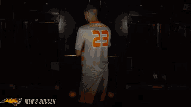 a man in an orange and white striped shirt with the number 29 on it