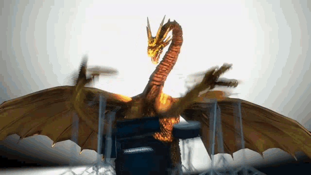 a statue of a dragon with three heads and wings is on a table