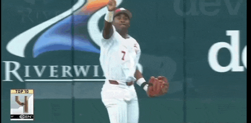 a baseball player with the number 7 on his jersey stands in front of a riverview sign