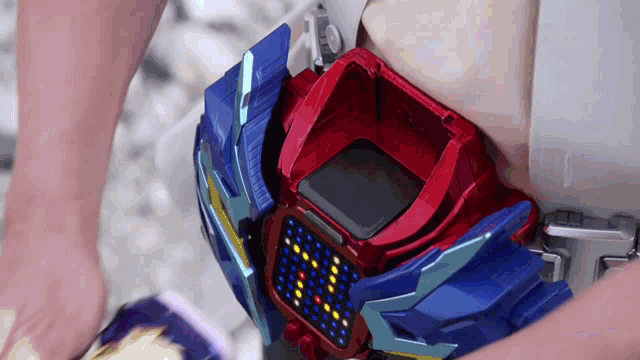 a person is holding a red and blue item that says ' a ' on it