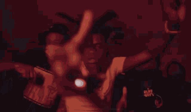 a group of men without shirts are dancing in the dark