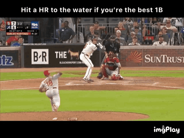 a baseball player with the number 18 on his back swings at the ball
