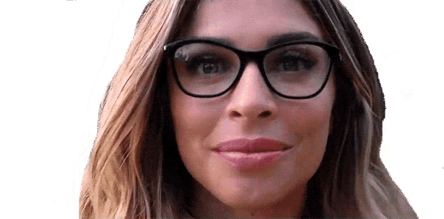 a close up of a woman wearing glasses and smiling