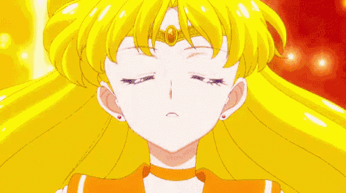 a close up of a girl with long yellow hair and blue eyes .