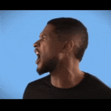 a man in a black shirt is screaming with his mouth wide open