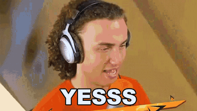 a man wearing headphones with the word yesss written on it