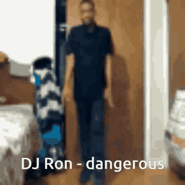 a man standing in front of a door with the words dj ron - dangerous above him