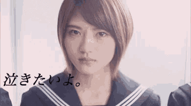 a girl in a sailor suit is crying in front of a group of people .