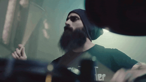 a man with a beard is wearing a black shirt that says " jailer " on it