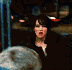 a woman wearing headphones is making a funny face