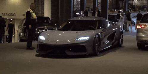 a silver sports car is parked in a parking lot
