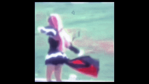 a blurry picture of a woman with pink hair holding a red and black flag .