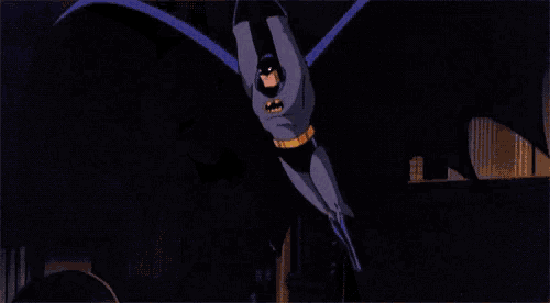 a close up of a cartoon batman with a yellow bat logo on his chest