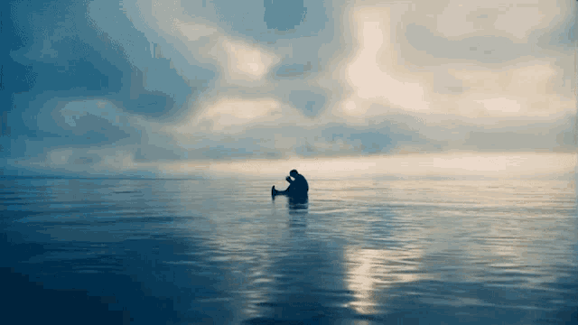 a person in a boat in the middle of a body of water