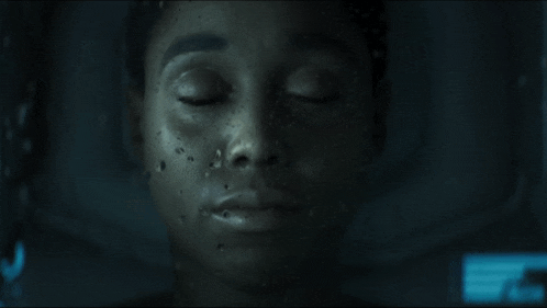 a close up of a woman 's face in the dark
