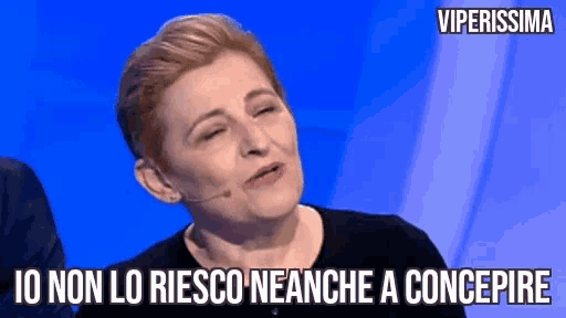 a woman is making a funny face while wearing a microphone and a caption that says viperissima .