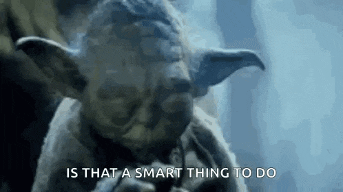 a close up of a statue of yoda smoking a pipe .