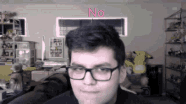 a man wearing glasses has the word no written on his face