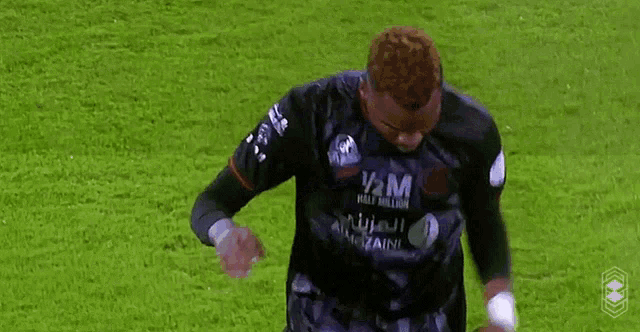 a soccer player wearing a shirt that says half million