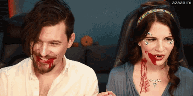 a man and a woman with blood on their faces and azaaami written on the bottom right