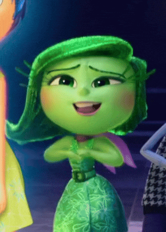 a green cartoon character with a purple scarf around her neck is smiling