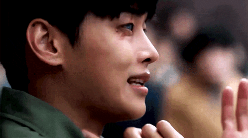a close up of a person 's face with a hand on their face .