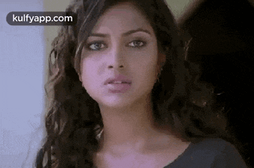 a close up of a woman 's face with a serious expression .