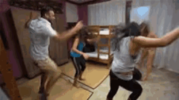 a group of people are dancing together in a room with bunk beds .