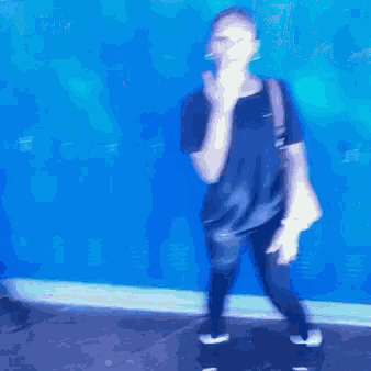 a woman standing in front of a blue locker