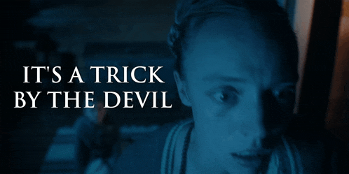 a woman in a dark room with the words it 's a trick by the devil