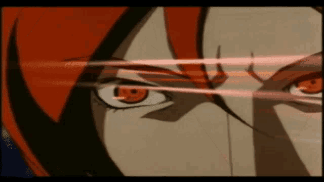 a close up of a cartoon character 's eyes with red hair