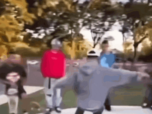 a blurry picture of a group of people dancing in a park