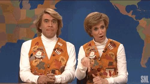 a man and a woman on a snl show wearing sweater vests