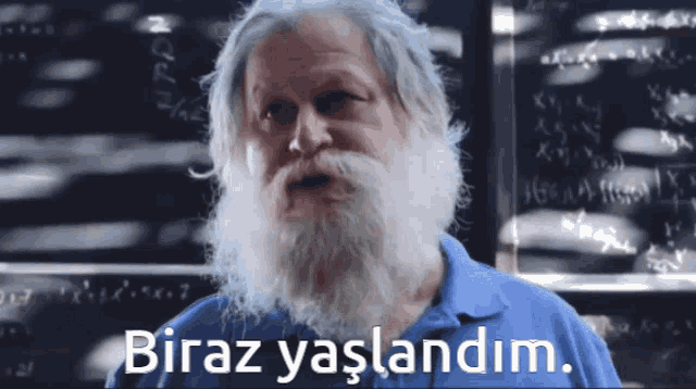 a man with a beard and a blue shirt says biraz yaşlandim