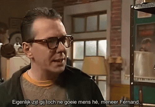 a man wearing glasses says eigenlijk zit gij toch ne goeie mens he meneer fernand in a foreign language