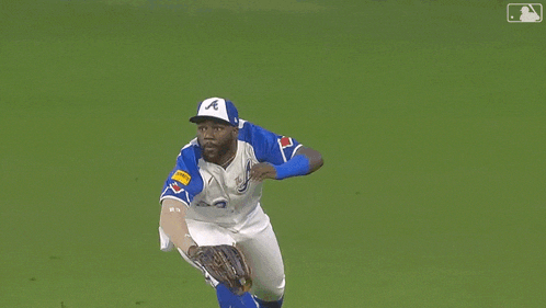 a baseball player wearing number 23 is laying on the grass