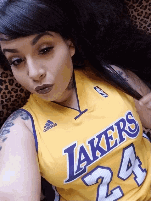 a woman wearing a lakers jersey number 24
