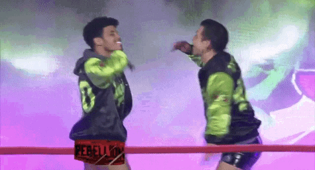 two men are fighting in a boxing ring and one of the shorts says rebellion