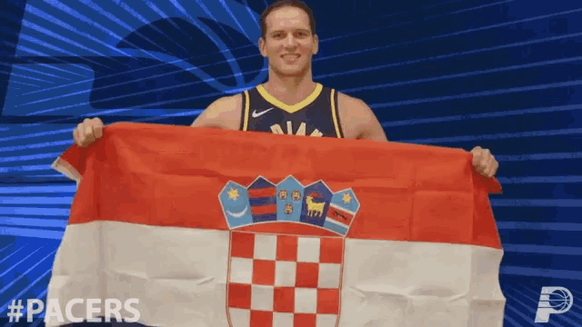 a man in a pacers jersey holding a flag