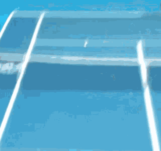 a tennis player is hitting a tennis ball on a blue court