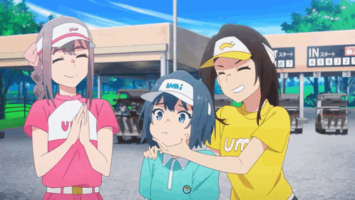 a girl wearing a hat that says umi is being held by another girl