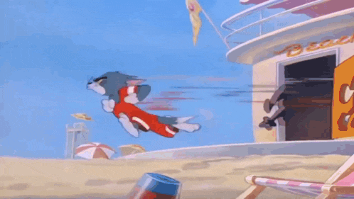 tom and jerry are standing under an umbrella on a beach .