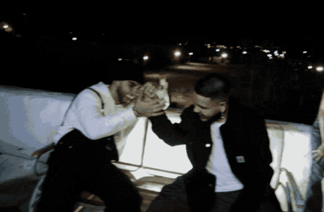a man in a carhartt jacket is giving another man a middle finger