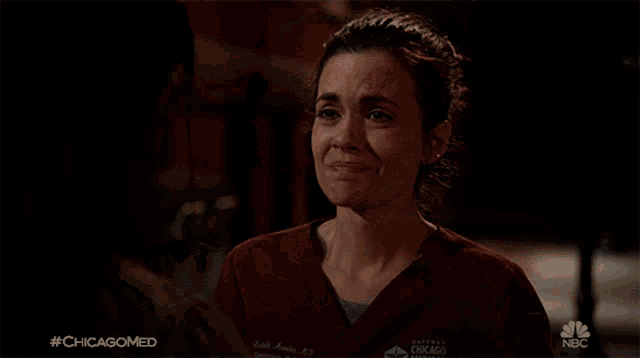 a woman is crying while being hugged by a man in a nbc ad