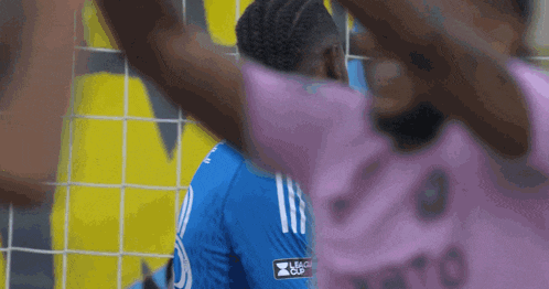 a person wearing a blue shirt with the word league cup on it