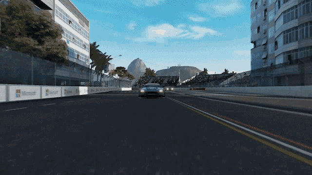 a car is driving down a road with microsoft banners on the side of it