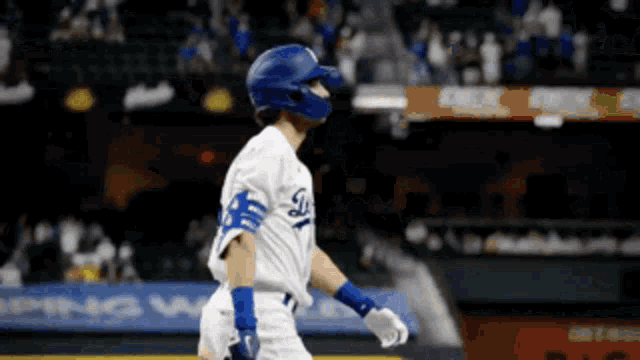 a baseball player wearing a helmet and a dodgers uniform
